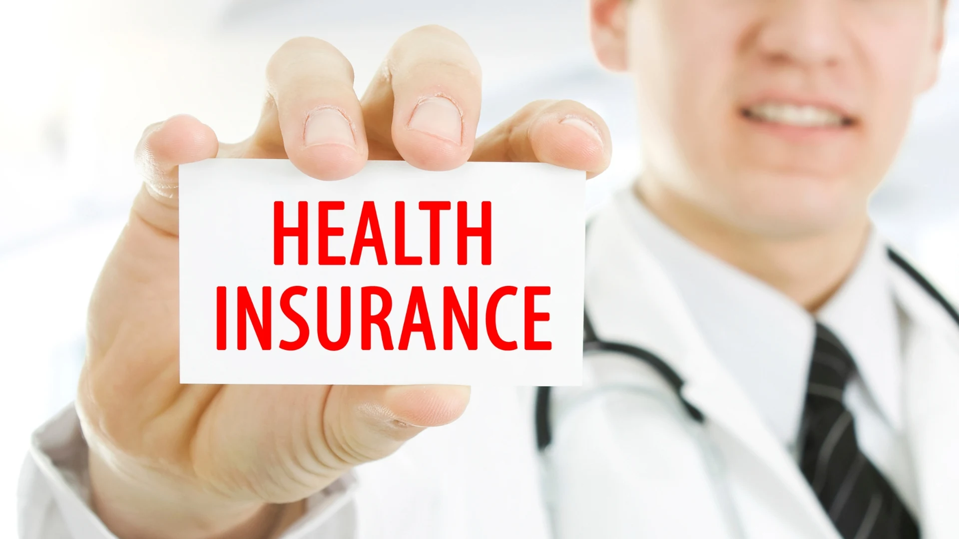 Health insurance card and laser eye surgery equipment representing coverage questions for vision correction